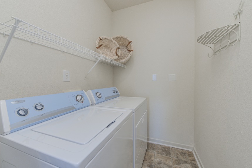 Laundry room with storage space in Zionsville.